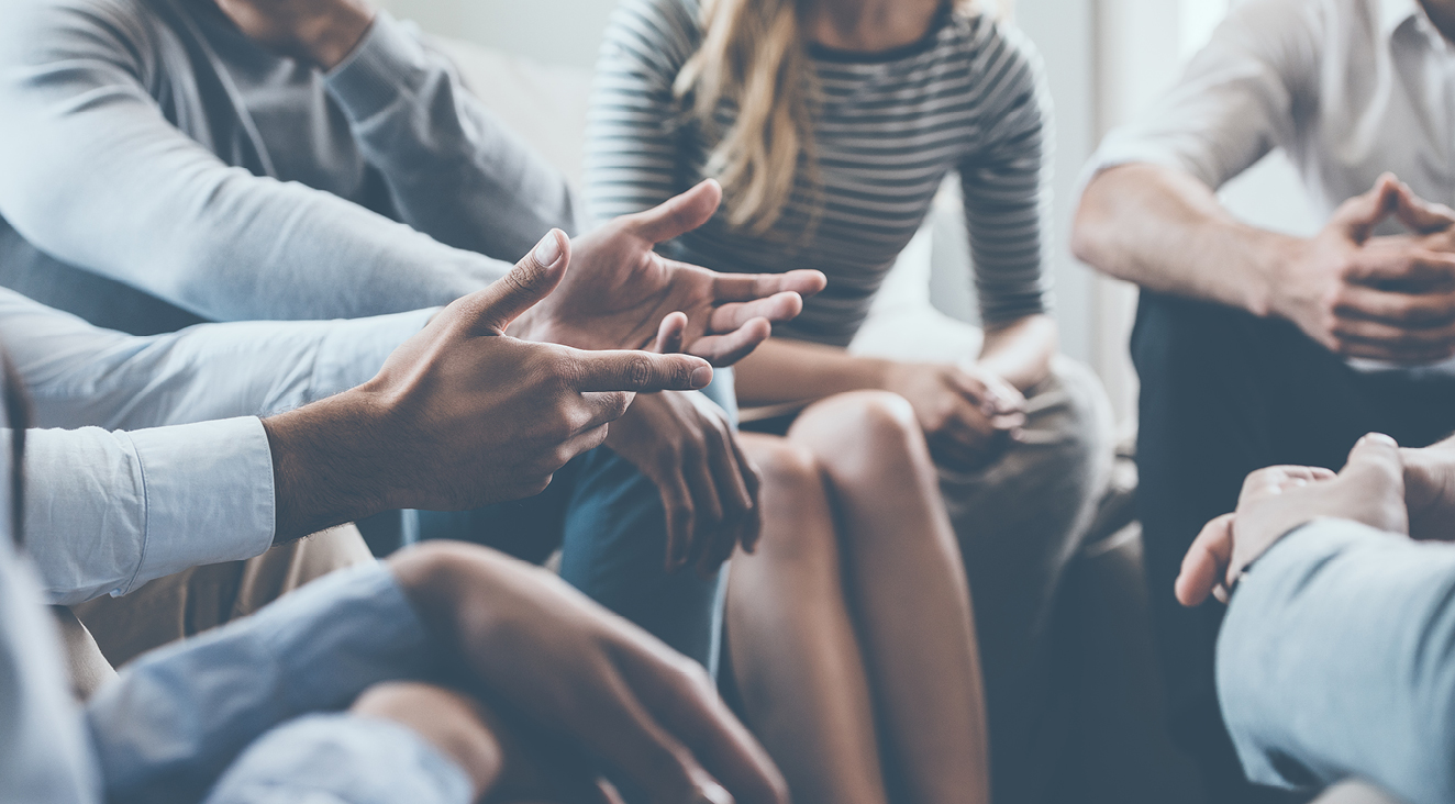 a group of adults sitting in a circle